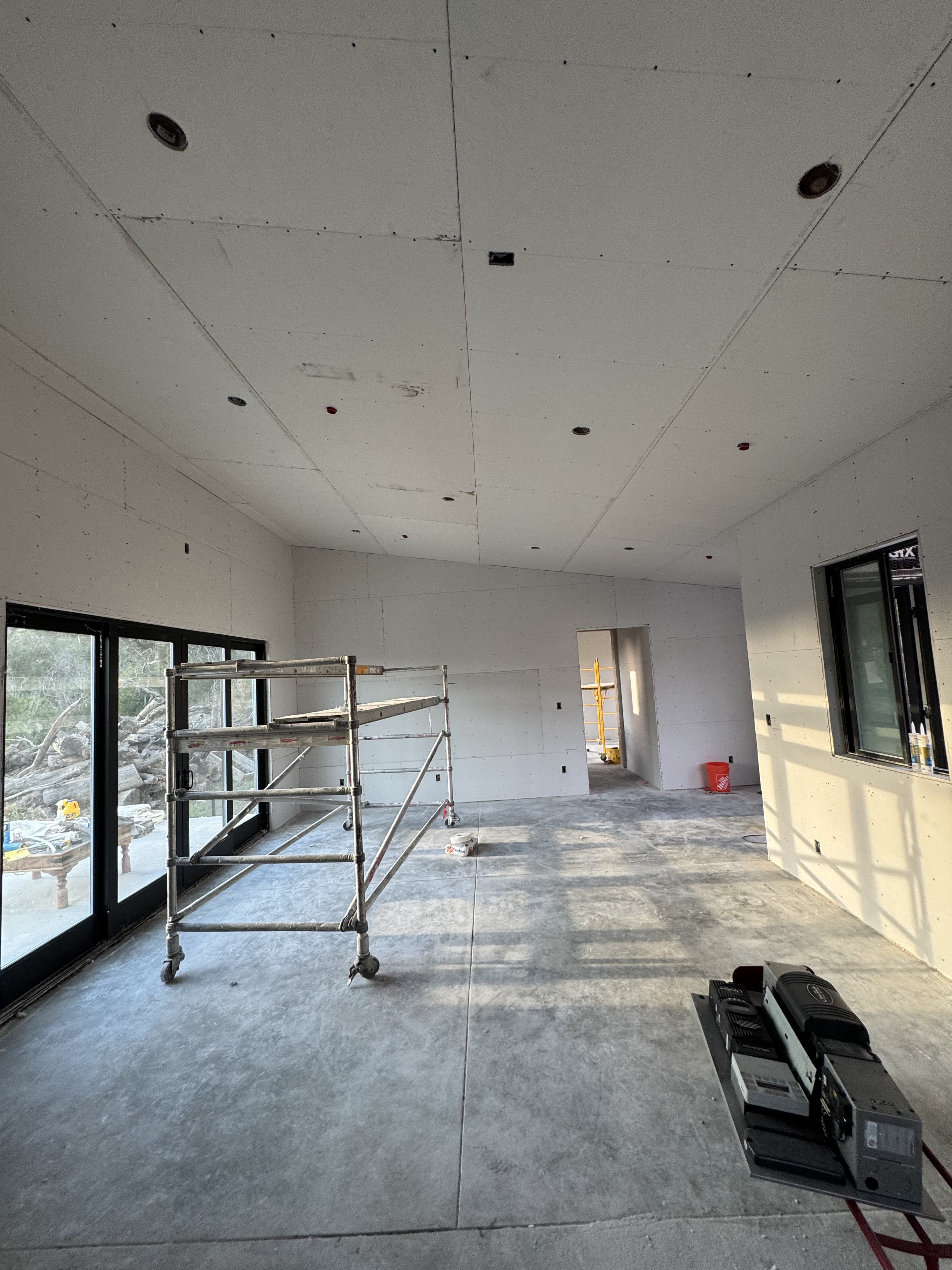 Drywall materials staged in an unfinished room