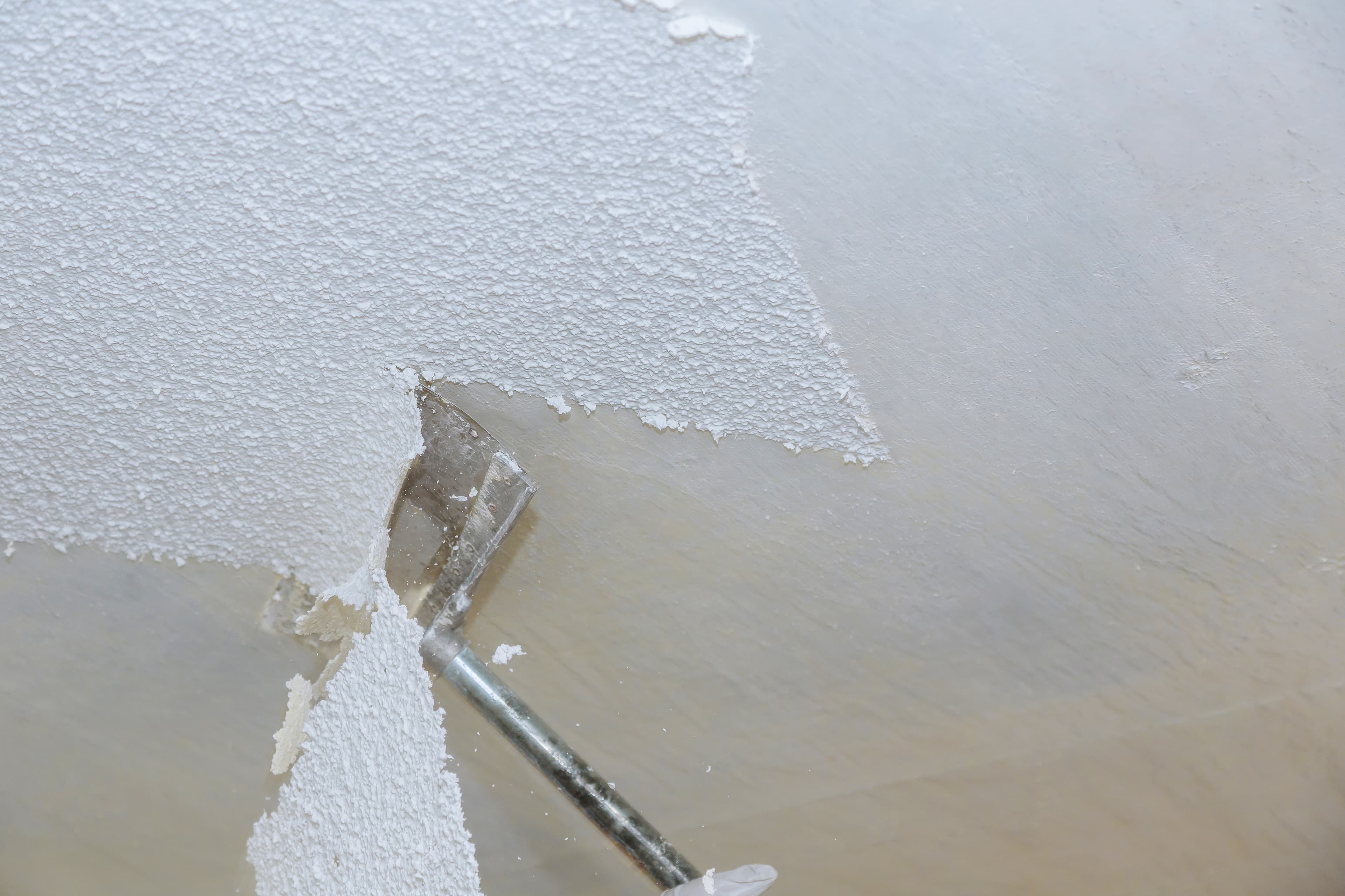 Popcorn ceiling texture being scraped off